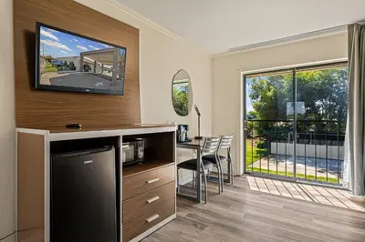 a kitchen and dining room with a table and a window at Heritage Inn Express Roseville in Roseville