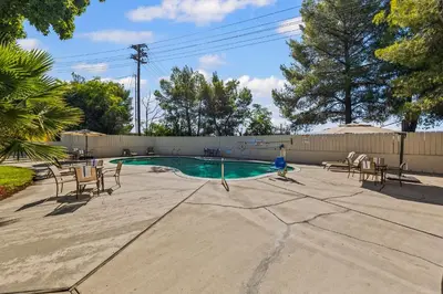 a swimming pool with chairs and a fire hydrant at Heritage Inn Express Roseville in Roseville