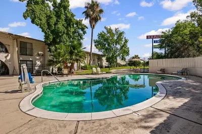 a swimming pool with blue water in a building at Heritage Inn Express Roseville in Roseville