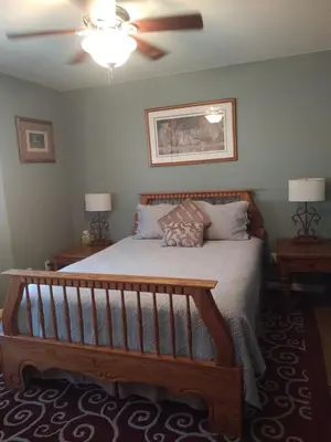 a bedroom with a bed and a ceiling fan at Engvadonia Yosemite B and B in Mariposa