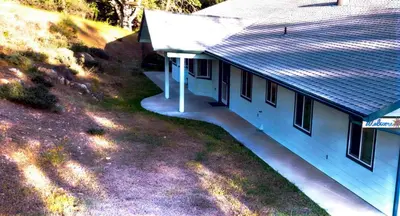 an aerial view of a white house with a porch at Engvadonia Yosemite B and B in Mariposa
