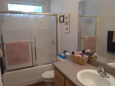 a bathroom with a shower and a toilet and a sink at Engvadonia Yosemite B and B in Mariposa