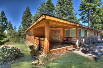 a log cabin with a porch and a deck at Prestigious Home South Lake Tahoe in South Lake Tahoe