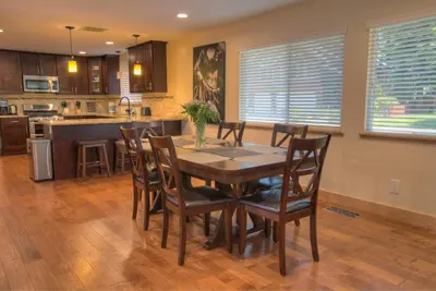 a kitchen and dining room with a wooden table and chairs at Prestigious Home South Lake Tahoe in South Lake Tahoe