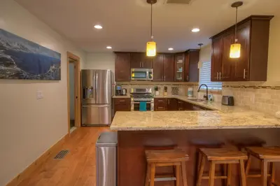 a kitchen with wooden cabinets and stainless steel appliances at Prestigious Home South Lake Tahoe in South Lake Tahoe