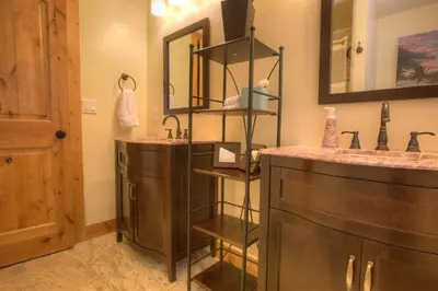 a bathroom with two sinks and a mirror at Prestigious Home South Lake Tahoe in South Lake Tahoe