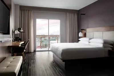 a hotel room with a bed and a desk and a window at Visalia Marriott at the Convention Center in Visalia