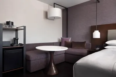 a hotel room with a table and a bed at Visalia Marriott at the Convention Center in Visalia