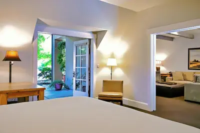 a bedroom with a bed and a living room at Appellation Lodi - Wine & Roses Resort and Spa in Lodi