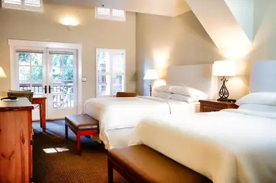 a hotel room with two beds and a window at Appellation Lodi - Wine & Roses Resort and Spa in Lodi