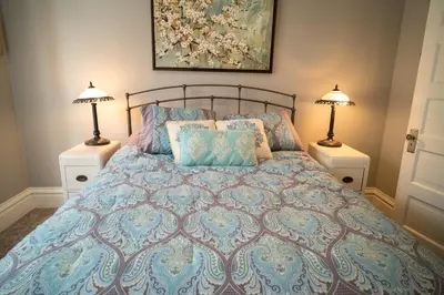 a bedroom with a bed with pillows and two lamps at Poppy Sister Inn in Lodi