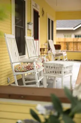 two white chairs and a table on a porch at Poppy Sister Inn in Lodi