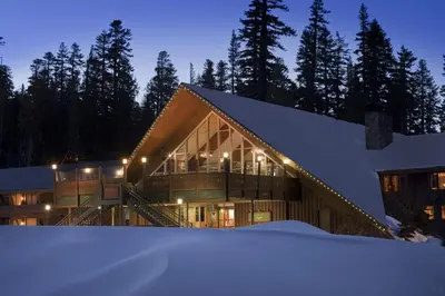 a building in the snow at night at Mammoth Mountain Inn in Mammoth Lakes