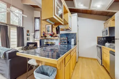 a kitchen with a large island in a tiny house at Saddle Road Condo in Bijou Park
