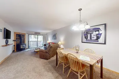 a living room with a dining room table and a couch at The Summit 206 in Old Mammoth