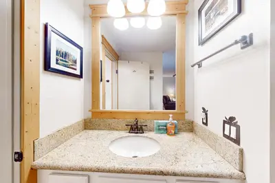 a bathroom with a sink and a mirror at The Summit 206 in Old Mammoth