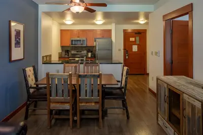 a dining room and kitchen with a table and chairs at The Village Lodge in Mammoth Lakes