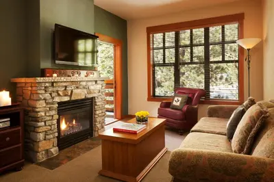 a living room with a couch and a fireplace at The Village Lodge in Mammoth Lakes