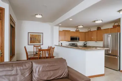 a kitchen and dining room with a couch and a table at Juniper Springs Resort in Mammoth Lakes