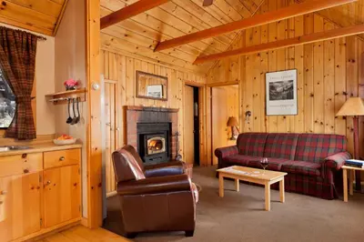 a living room with a couch and a fireplace at Tamarack Lodge in Mammoth Lakes