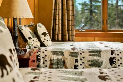 a bedroom with a bed and a window at Tamarack Lodge in Mammoth Lakes