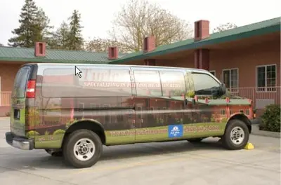 a green van parked in front of a building at Turlock Inn in Turlock