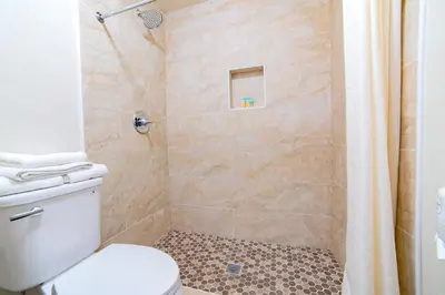 a bathroom with a shower with a toilet at Turlock Inn in Turlock