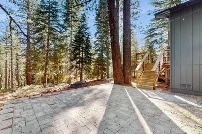an empty driveway leading to a house with trees at Lazy Bear Retreat in Mevers