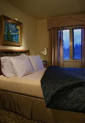 a bedroom with a bed with white pillows and a window at Lodge at Kingsbury Crossing in Stateline