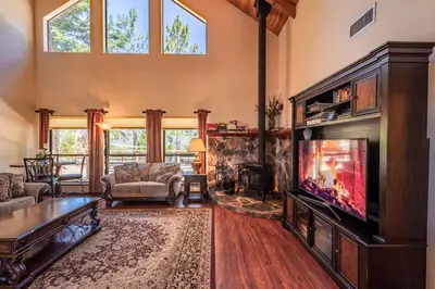 a living room with a television and a fireplace at Mountain View Playhouse Near Yosemite & Bass Lake in Oakhurst