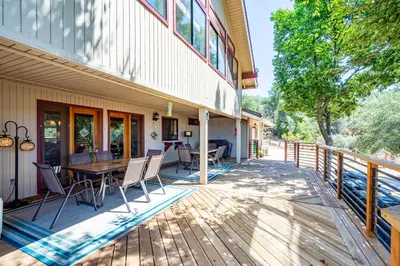 a deck with chairs and a table on a house at Mountain View Playhouse Near Yosemite & Bass Lake in Oakhurst