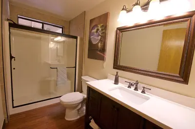 a bathroom with a toilet and a sink and a shower at Mountain View Playhouse Near Yosemite & Bass Lake in Oakhurst