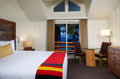 a bedroom with a bed and a table and chairs at Sunnyside Resort and Lodge in Tahoe City
