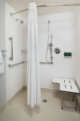 a bathroom with a shower with a shower curtain at Sonesta ES Suites Fresno in Fresno