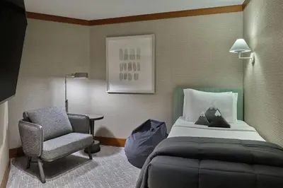 a hotel room with a bed and a chair at The Ritz-Carlton, Lake Tahoe in Truckee