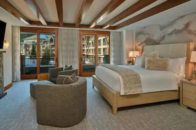 a bedroom with a bed and a couch and a chair at The Ritz-Carlton, Lake Tahoe in Truckee