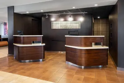 a lobby with two reception desks in a building at Courtyard Sacramento Rancho Cordova in Rancho Cordova