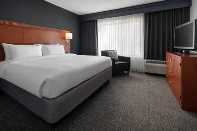 a hotel room with a bed and a television at Courtyard Sacramento Rancho Cordova in Rancho Cordova