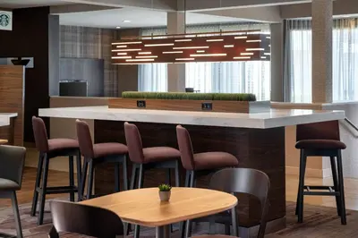 a lobby with a bar with chairs and tables at Courtyard Sacramento Rancho Cordova in Rancho Cordova