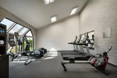 a gym with treadmills and a row of tread machines at Courtyard Sacramento Rancho Cordova in Rancho Cordova