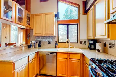 a kitchen with wooden cabinets and a sink at Commonwealth Retreat in Kings Beach