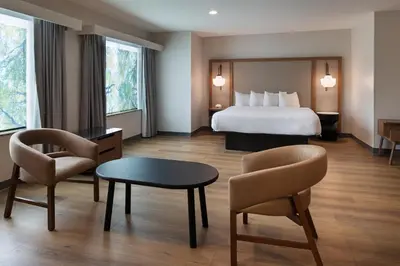 a hotel room with a bed and a table and chairs at Fairfield Inn Sacramento Cal Expo in Sacramento