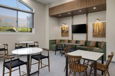 a waiting room with tables and chairs at Fairfield Inn Sacramento Cal Expo in Sacramento