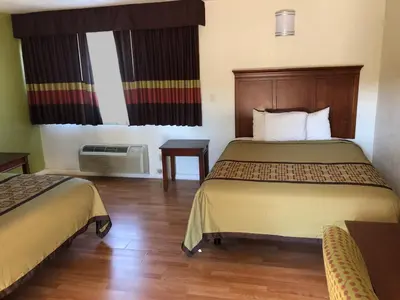 a hotel room with two beds and a window at Americas Best Value Inn Visalia in Visalia