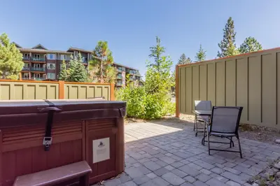 a patio with two chairs and a hot tub at Juniper Crest 3 in Old Mammoth