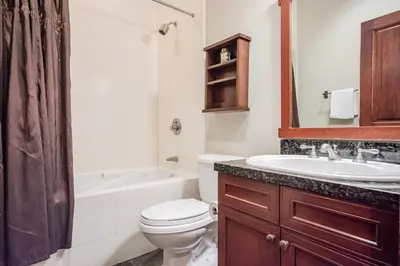a bathroom with a toilet and a sink and a tub at Juniper Crest 3 in Old Mammoth