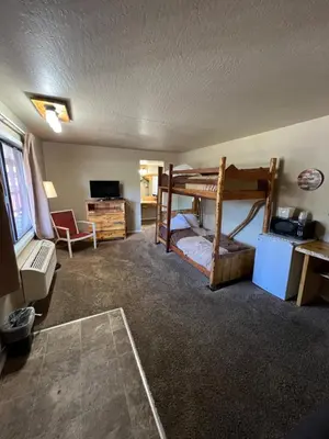 a room with two bunk beds and a desk at The Trailhead in South Lake Tahoe