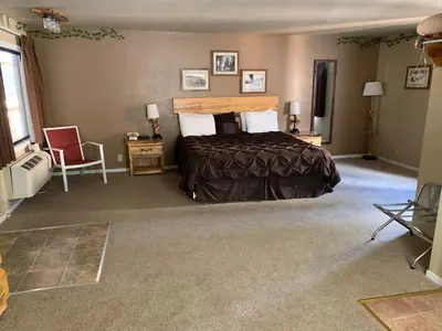 a bedroom with a bed and a chair in it at The Trailhead in South Lake Tahoe
