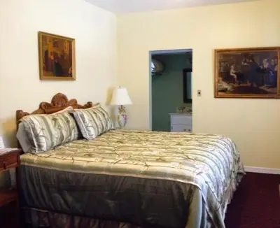 a bedroom with a large bed in a room at Historic Cary House Hotel in Placerville