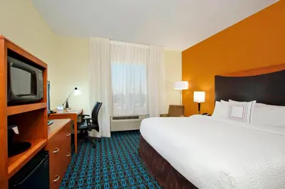 a hotel room with a bed and a television at Fairfield Inn & Suites Fresno Clovis in Clovis